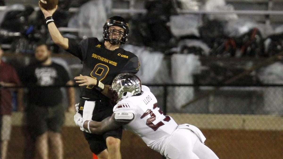 Southern Miss quarterback Nick Mullens is hit as he releases the ball by Troy linebacker William Lloyd in Hattiesburg.