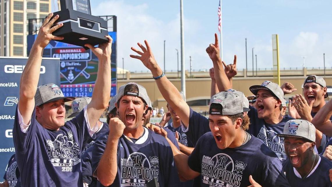 Rice right fielder Charlie Warren holds up the C-USA championship trophy as the team celebrate their 5-4 win over Southern Mississippi at MGM Park in Biloxi on Sunday.