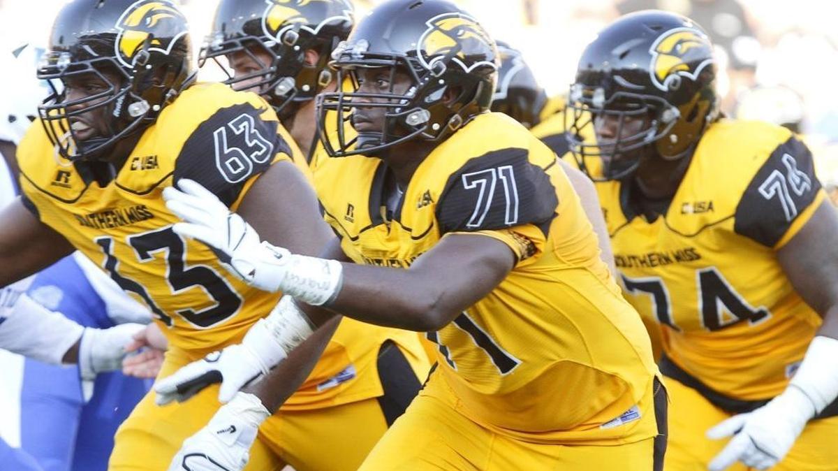 Southern Miss left tackle Paul Gainer(71) of Gautier leads a running play against Kentucky during the third quarter of their game at M.M. Roberts Stadium in Hattiesburg on Sept. 2, 2017.