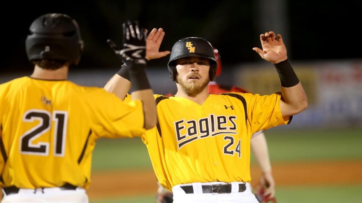 Southern Miss senior Dylan Burdeaux, right, high fives teammate Hunter Slater after crossing home plate at MGM Park on Tuesday. Burdeaux extended his hitting streak to 16 straight games against Tulane Wednesday.