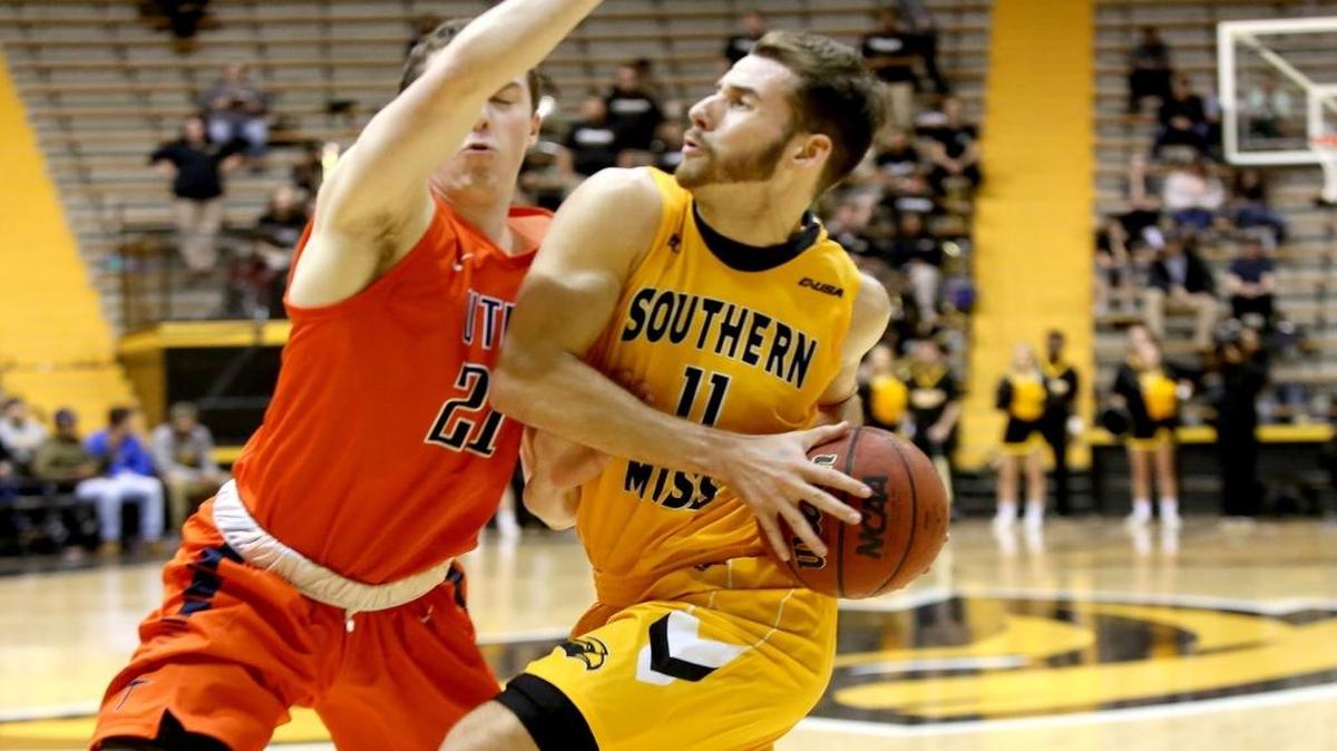 Southern Miss guard Michael Ramey pushes past UTEP's Trey Touchet on his way to the basket on Jan. 28, 2016, in Hattiesburg.