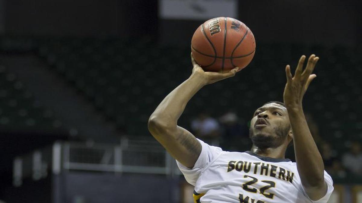 Southern Mississippi guard Quinton Campbell (22) goes up for a shot over Hawaii guard Noah Allen, left at the Diamond Head Classic, Sunday.