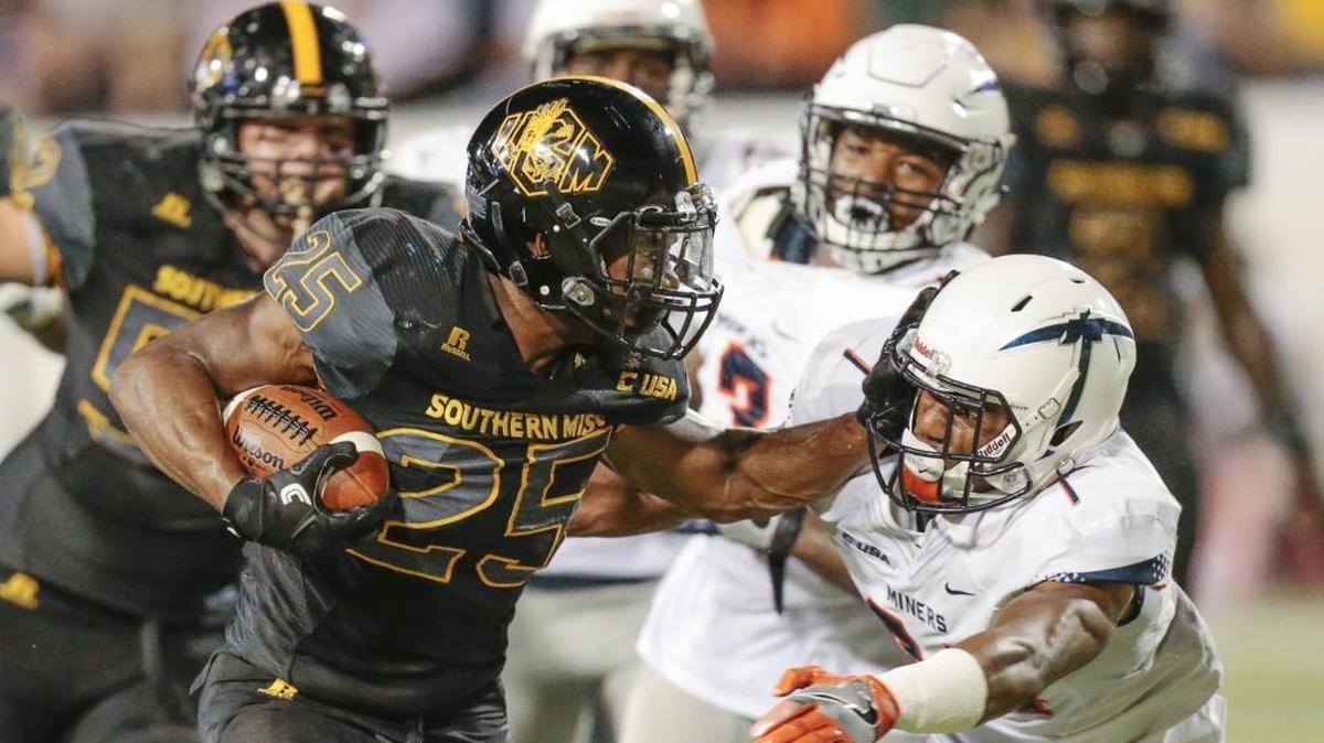 Southern Miss running back Ito Smith (25) stiff arms a defender during the game against at M.M. Roberts Stadium on Oct, 14, 2017.