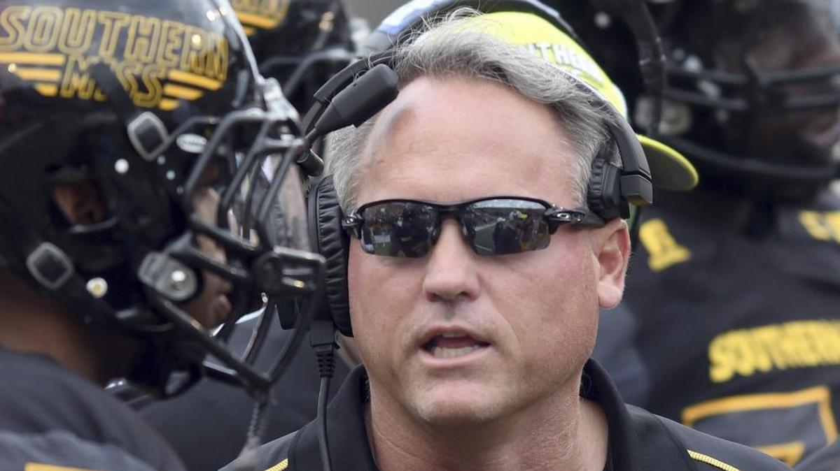 Southern Miss head coach Jay Hopson speaks with his players during a game against Charlotte at M.M. Roberts Stadium on Nov. 18.