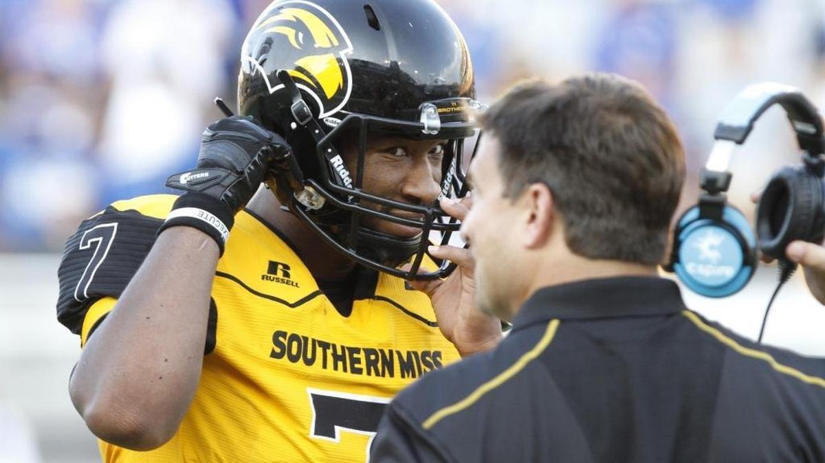 Southern Miss quarterback Kwadra Griggs talks to offensive coordinator Shannon Dawson during the third quarter of their game against Kentucky at M.M. Roberts Stadium in Hattiesburg on Sept. 2.