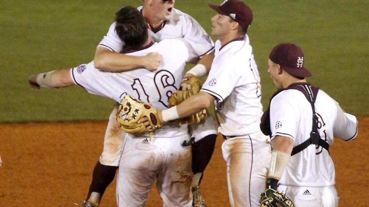 Josh Lovelady (16) lifts Cody Brown while they celebrate their Hattiesburg Regional title Monday at Pete Taylor Park in Hattiesburg.