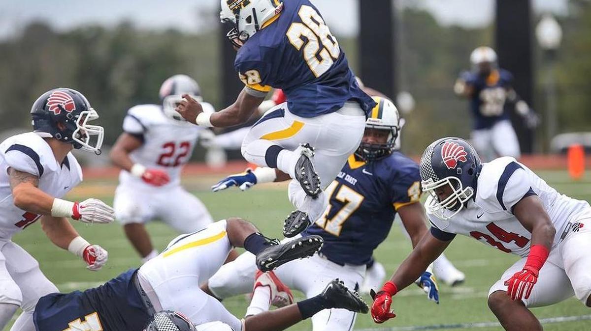Gulf Coast running back T'Rod Daniels jumps over the Itawamba defense while running the ball on Saturday, October 31, 2015. The Bulldogs defeated Itawamba to move on in the MACJC playoffs.