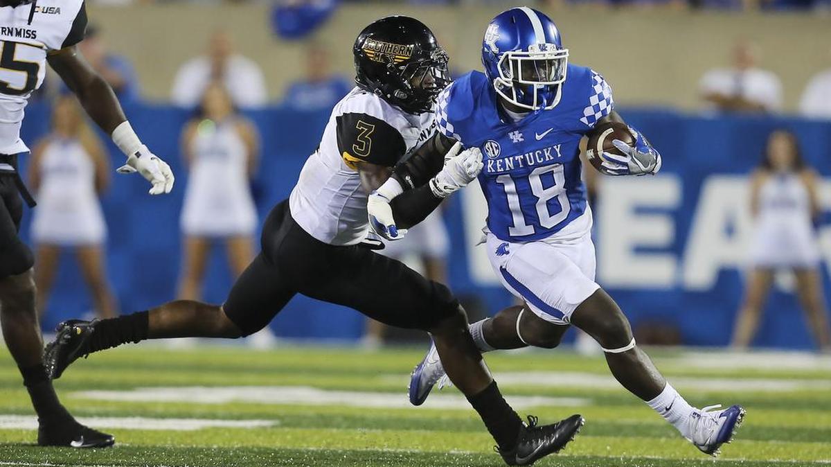 Kentucky running back Stanley Boom Williams tries to get past the tackle of Southern Miss defensive back Cornell Armstrong Saturday in Lexington, Ky. Southern Mississippi won the game 44-35.