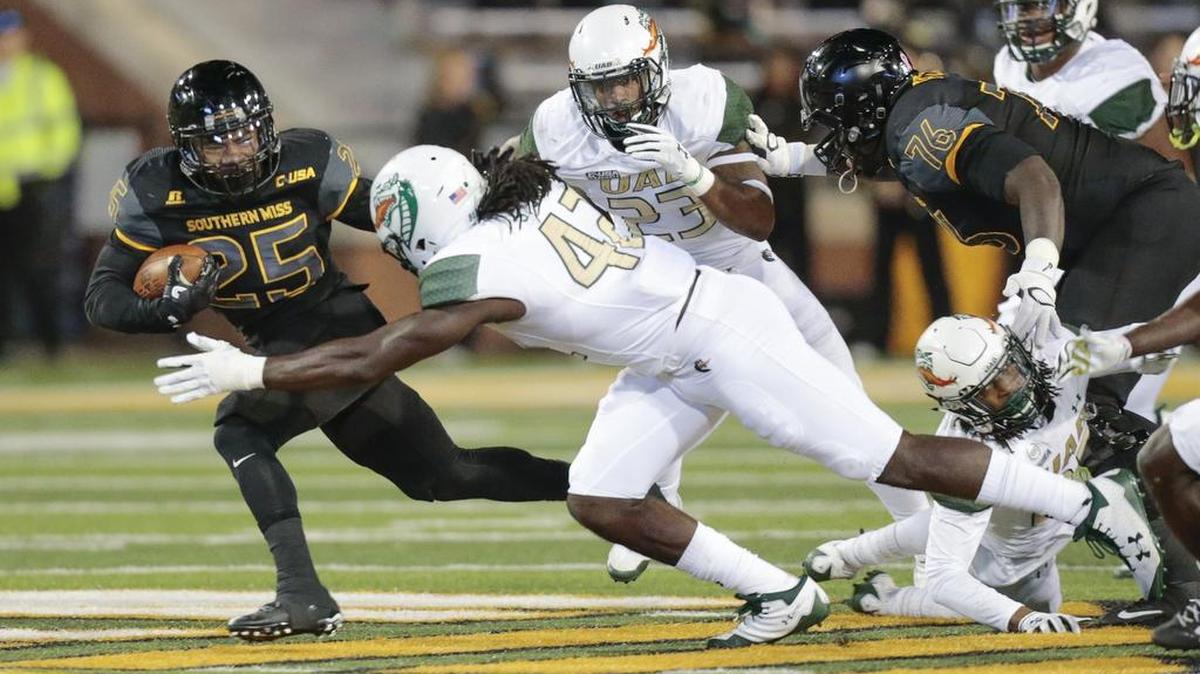 Southern Miss running back Ito Smith is tackled by UAB defensive lineman Shaq Jones during the game at M.M. Roberts Stadium Saturday.