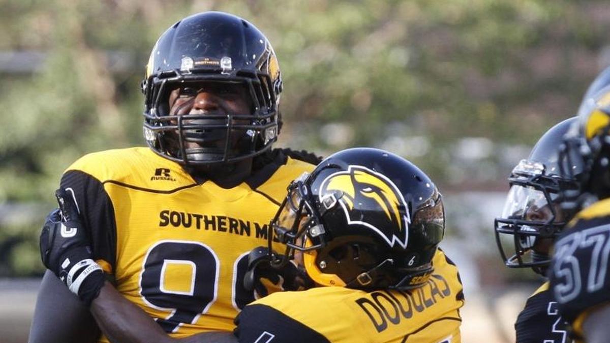 Southern Miss defensive end Jacques Turner, left, and defensive back Kelsey Douglas celebrate a sack by Turner against Kentucky in Hattiesburg on Sept. 2.