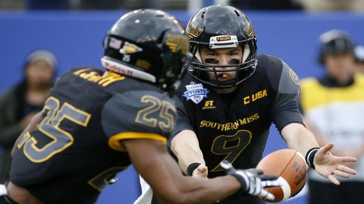 Southern Miss quarterback Nick Mullens (9) shovels the ball to running back Ito Smith (25) against Washington during the first half of the Heart of Dallas Bowl game on Dec. 26, 2015, in Dallas.