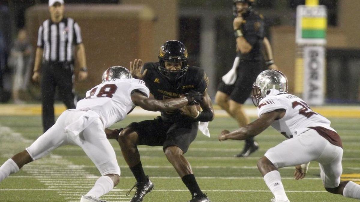 Southern Miss receiver D. J. Thompson his sandwiched by Troy defenders Blace Brown and Josh Marshall on Saturday in Hattiesburg.