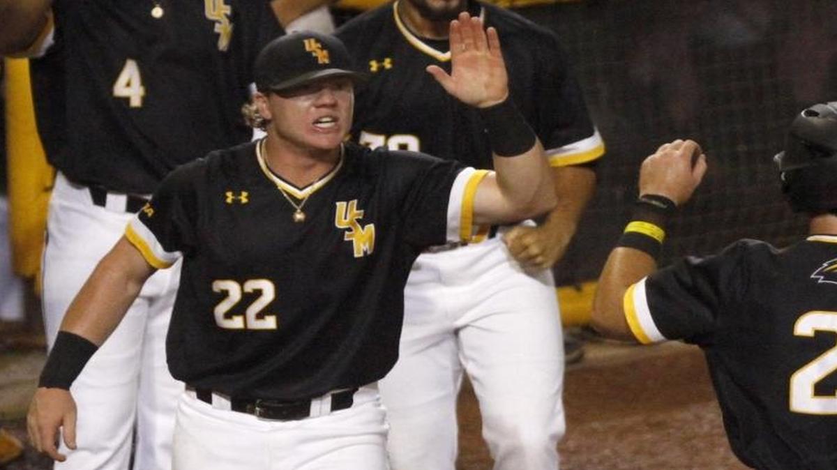 Taylor Braley of Southern Miss welcomes Hunter Slater to the dugout after scoring against Mississippi State during Hattiesburg Regional Tournament on June 5, 2017.