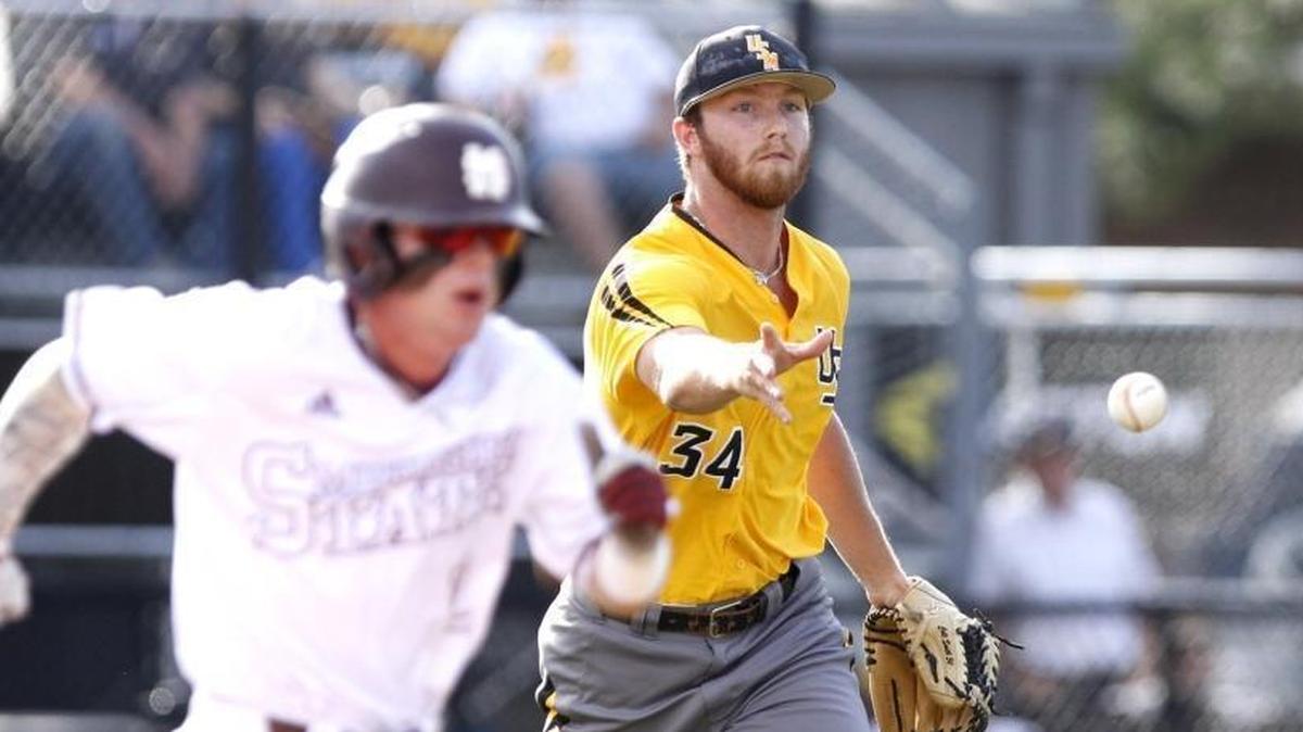 Southern Miss pitcher Colt Smith makes an under hand throw to first to get Mississippi State's Hunter Stovall out during Hattiesburg Regional Tournament on June 5 in Hattiesburg.