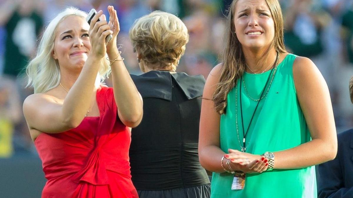 Brett Favre's daughters Brittany, left, and Breleigh, right, cheer as they watch a highlight reel of their father at Lambeau Field prior to his induction into the Packers Hall of Fame and the retirement of his No. 4 jersey, on July 18, 2015, in Green Bay, Wis. Breleigh has verbally committed to play volleyball at her father’s alma mater, Southern Miss.