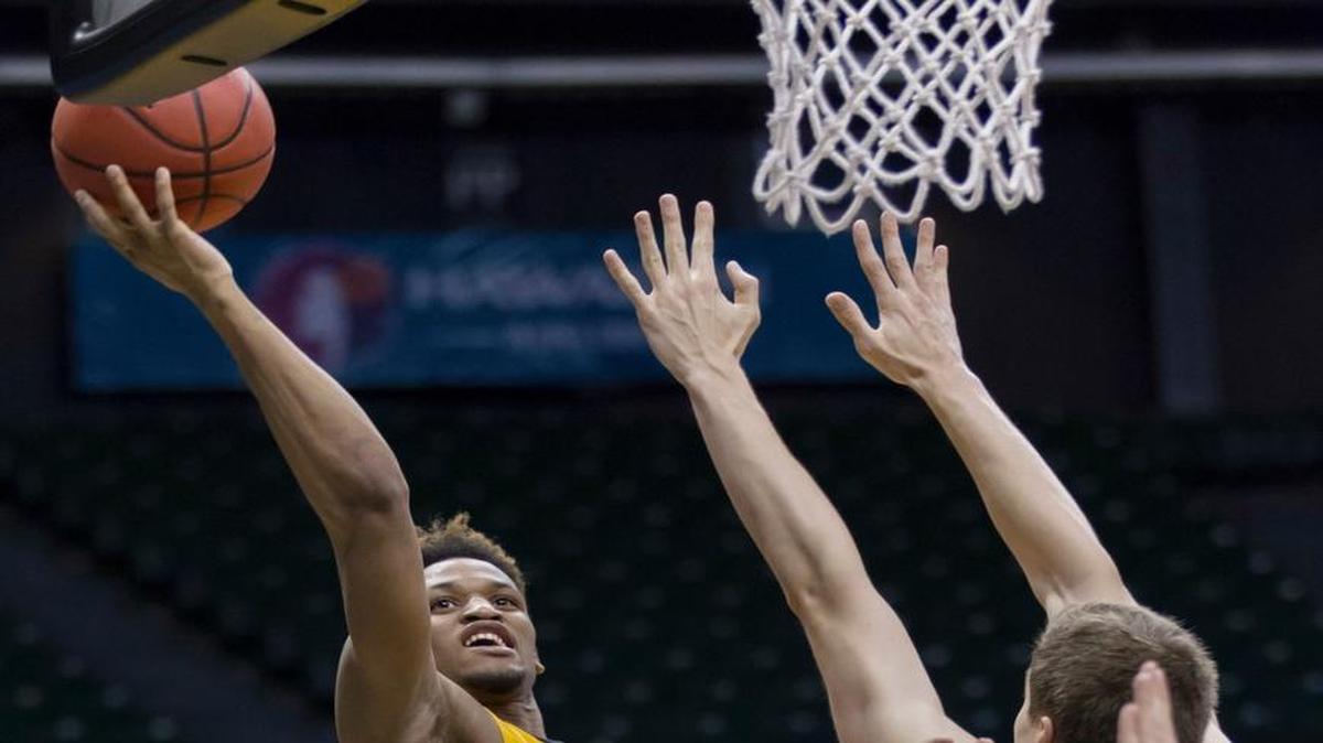 Southern Mississippi guard Cortez Edwards, left, shoots layup over Stephen F. Austin forward Samuli Nieminen (24) during the second half of an NCAA college basketball game at the Diamond Head Classic, Friday, in Honolulu. Stephen F. Austin won 67-64.