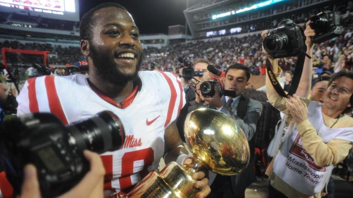 Former Ole Miss defender C.J. Johnson hoists the Golden Egg Trophy after helping lead the Rebels past Mississippi State 38-27 on Nov. 28, 2015 in Starkville. After serving as a graduate assistant at East Mississippi Community College and Florida Atlantic the last two seasons, Johnson has been hired to coach the defensive line at Pearl River Community College.
