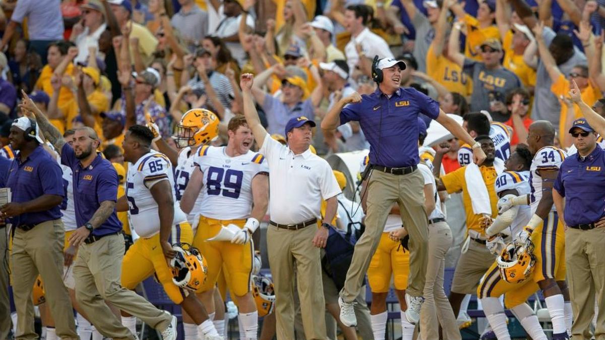 The LSU sideline erupts in celebration after a touchdown by wide receiver D.J. Chark during the second half of an NCAA college football game against Auburn in Baton Rouge in October 2017. Unnamed state lawmakers threatened to cut funding to LSU if players took a knee during the playing of the national anthem.