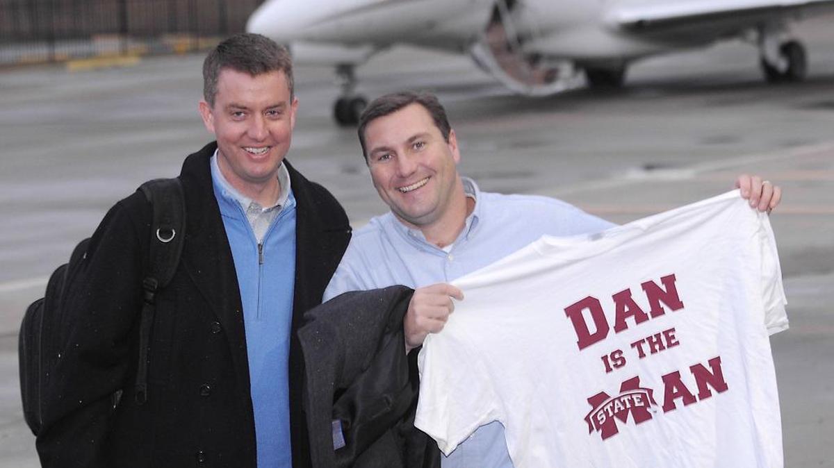 Mississippi State football coach Dan Mullen holds up a T-shirt presented to to him by MSU athletic director Greg Byrne, left, at the Starkville airport in December of 2008. Byrne is set to become the new athletic director at Alabama.