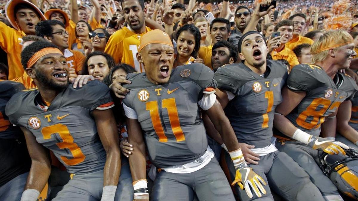 Tennessee quarterback Joshua Dobbs (11) celebrates with running back Jalen Hurd (1), wide receiver Josh Malone (3) and tight end Ethan Wolf (82) after defeating Florida 38-28 on Saturday in Knoxville, Tenn.