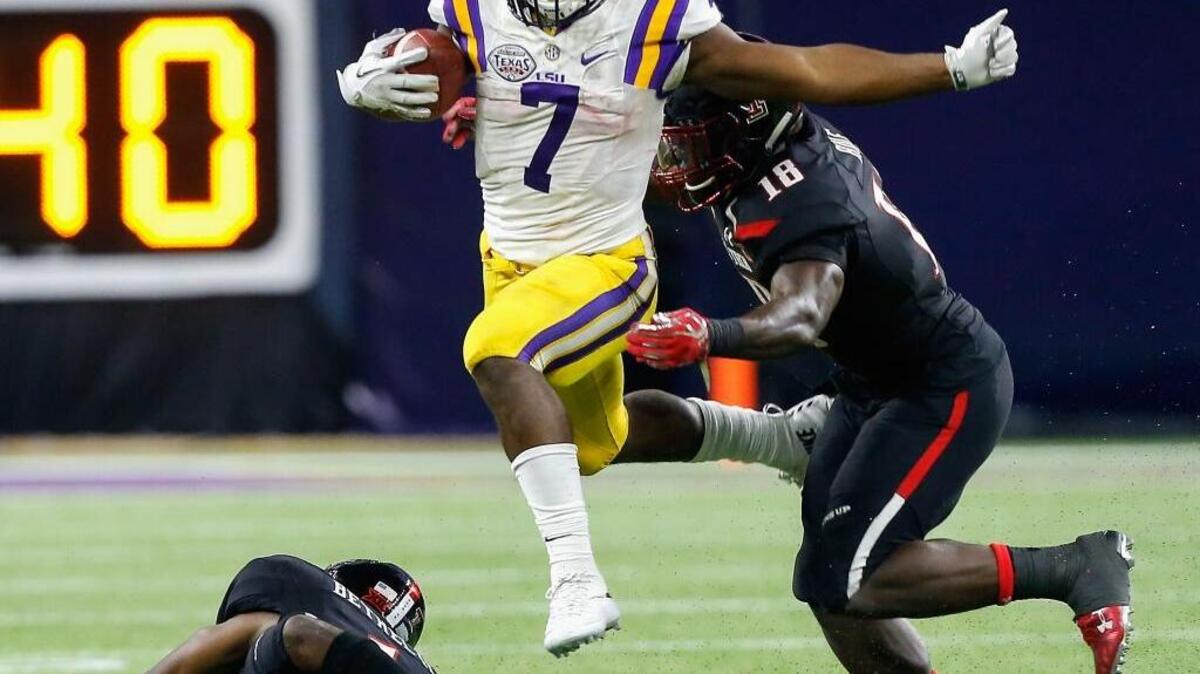 FILE - In this Dec. 29, 2015, file photo, LSU running back Leonard Fournette (7) rushes past Texas Tech defensive back Nigel Bethel, left, and linebacker Micah Awe (18) during the second half of the Texas Bowl in Houston.