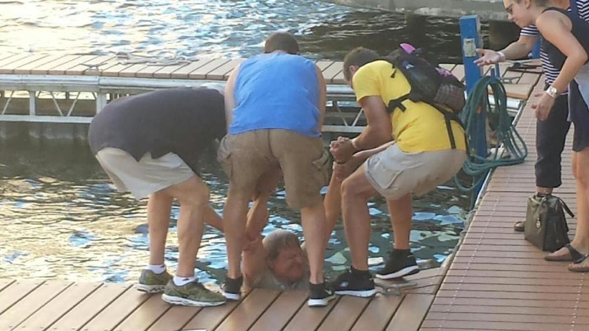 LSU fans from Baton Rouge rescue a man who had fallen into the Milwaukee River on Monday afternoon.
