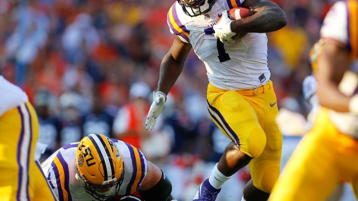 LSU running back Leonard Fournette (7) hurdles an Auburn player as he carries the ball in Auburn, Ala. Even after missing four games with injuries, Fournette just might be able to make some noise in the Heisman Trophy race.
