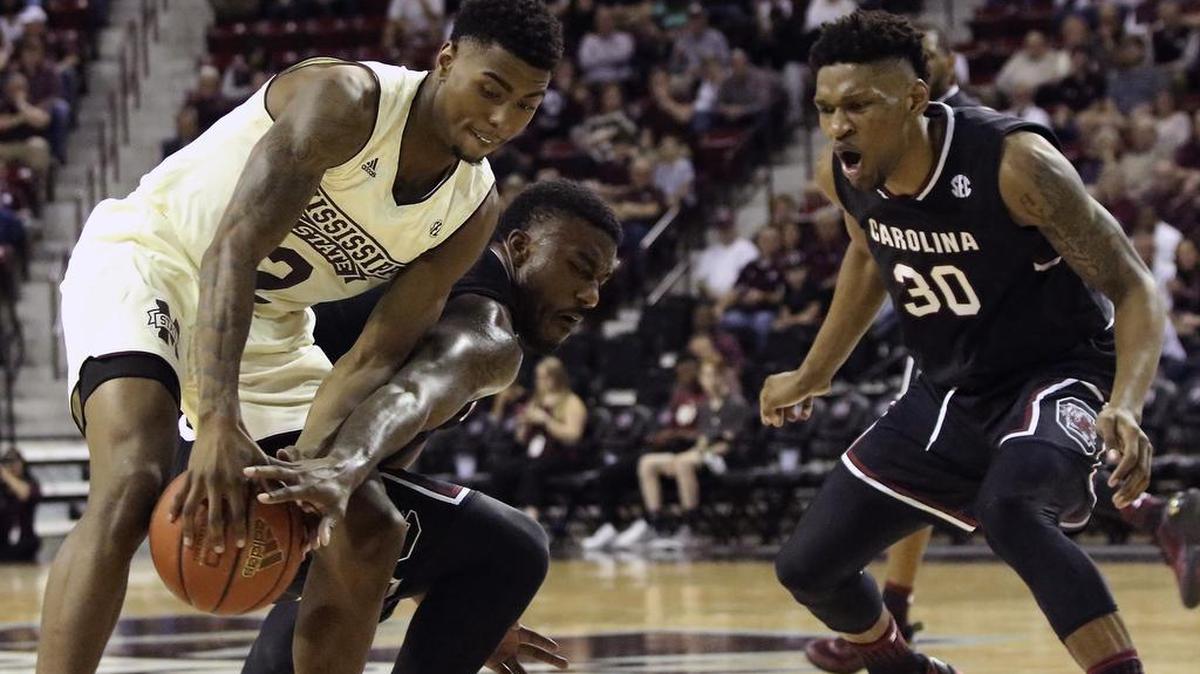 Mississippi State guard Eli Wright (2) grabs a rebound away from South Carolina guard Duane Notice (10) as South Carolina's Chris Silva (30) moves in.
