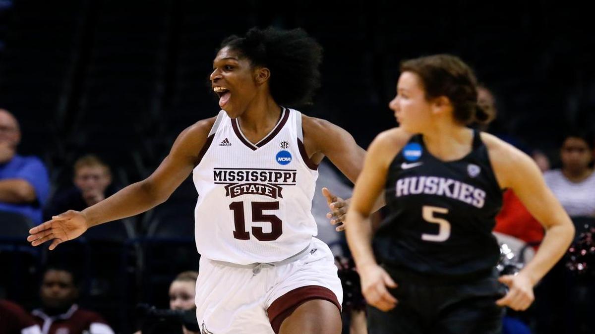 Mississippi State center Teaira McCowan (15) celebrates in front of Washington guard Natalie Romeo (5) during the second half of a regional semifinal of the NCAA women's tournament Friday in Oklahoma City. Mississippi State won 75-64.