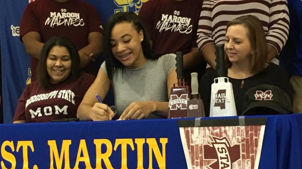 St. Martin senior Daphane White, center, signs with Mississippi State on Wednesday at St. Martin High School.