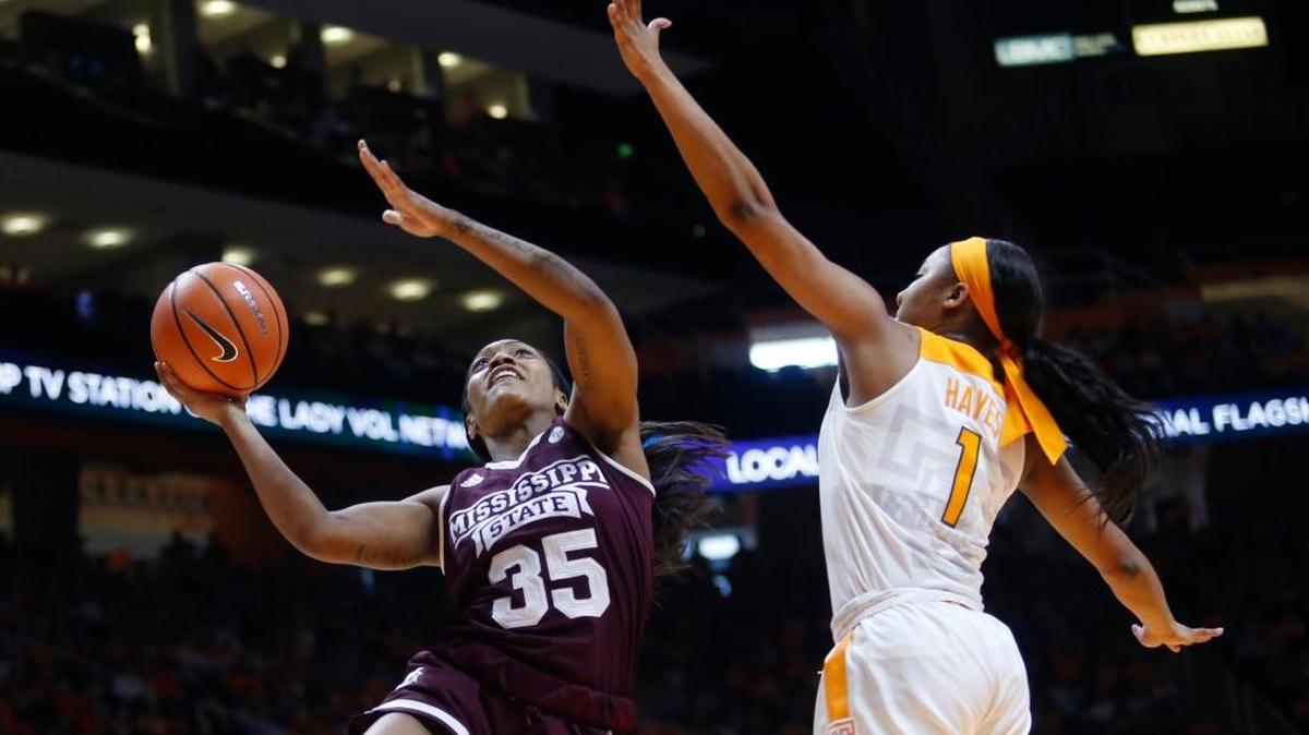 Mississippi State guard Victoria Vivians (35) is defended under the basket by Tennessee guard Anastasia Hayes (1).