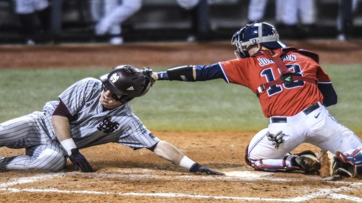 Mississippi State's Brent Rooker (19) scores against Ole Miss catcher Cooper Johnson (13).