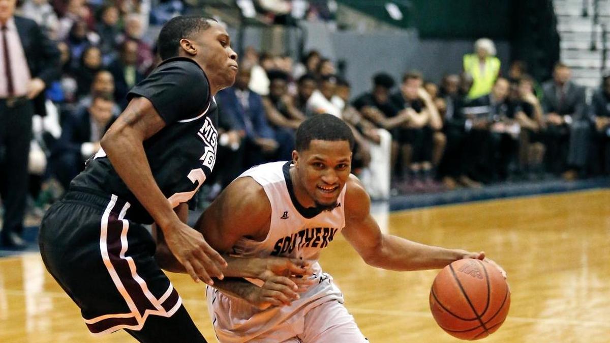 Southern Mississippi guard Cortez Edwards, right, dribbles past Mississippi State guard Tyson Carter (23).