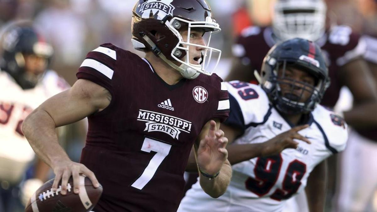 Mississippi State quarterback Nick Fitzgerald (7) rushes as Samford defensive lineman Ahmad Gooden (99) closes in for the tackle in Starkville Saturday.