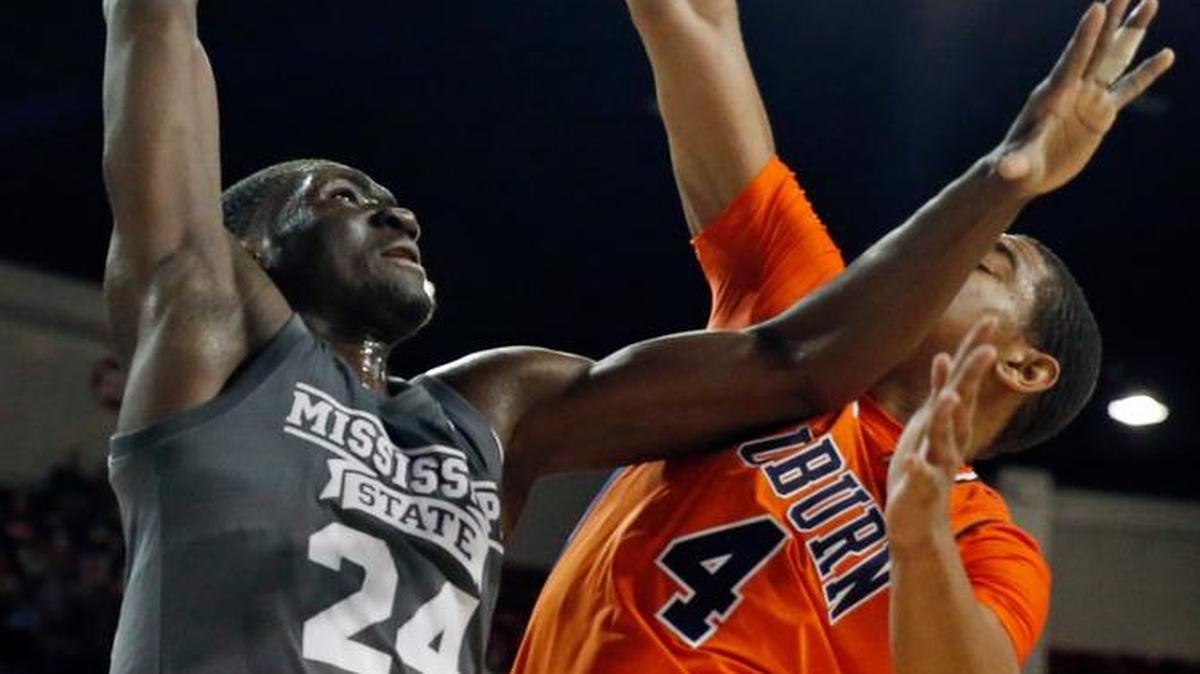 Mississippi State forward Abdul Ado (24) muscles the ball for a layup basket past the defense of Auburn forward Chuma Okeke (4).
