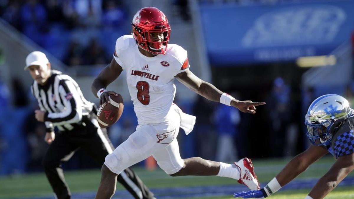 Louisville quarterback Lamar Jackson (8) scrambles past Kentucky defensive tackle Kordell Looney during the Taxslayer Bowl.