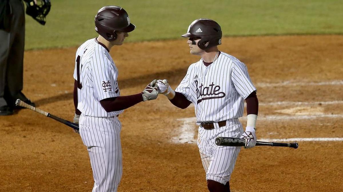 Mississippi State's Hunter Stovall, right, fist bumps teammate Justin Foscue after scoring a run on March 14 at MGM Park in Biloxi.