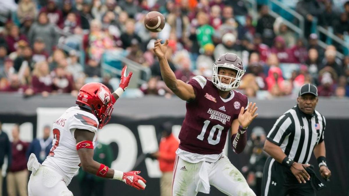 Mississippi State quarterback Keytaon Thompson (10) throws a pass while being chased by Louisville safety Chucky Williams (22) during the first half of the TaxSlayer Bowl.