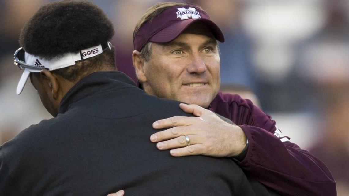 Mississippi State head coach Dan Mullen, hugs Texas A&M head coach Kevin Sumlin at midfield before the start of a game Saturday in College Station, Texas.
