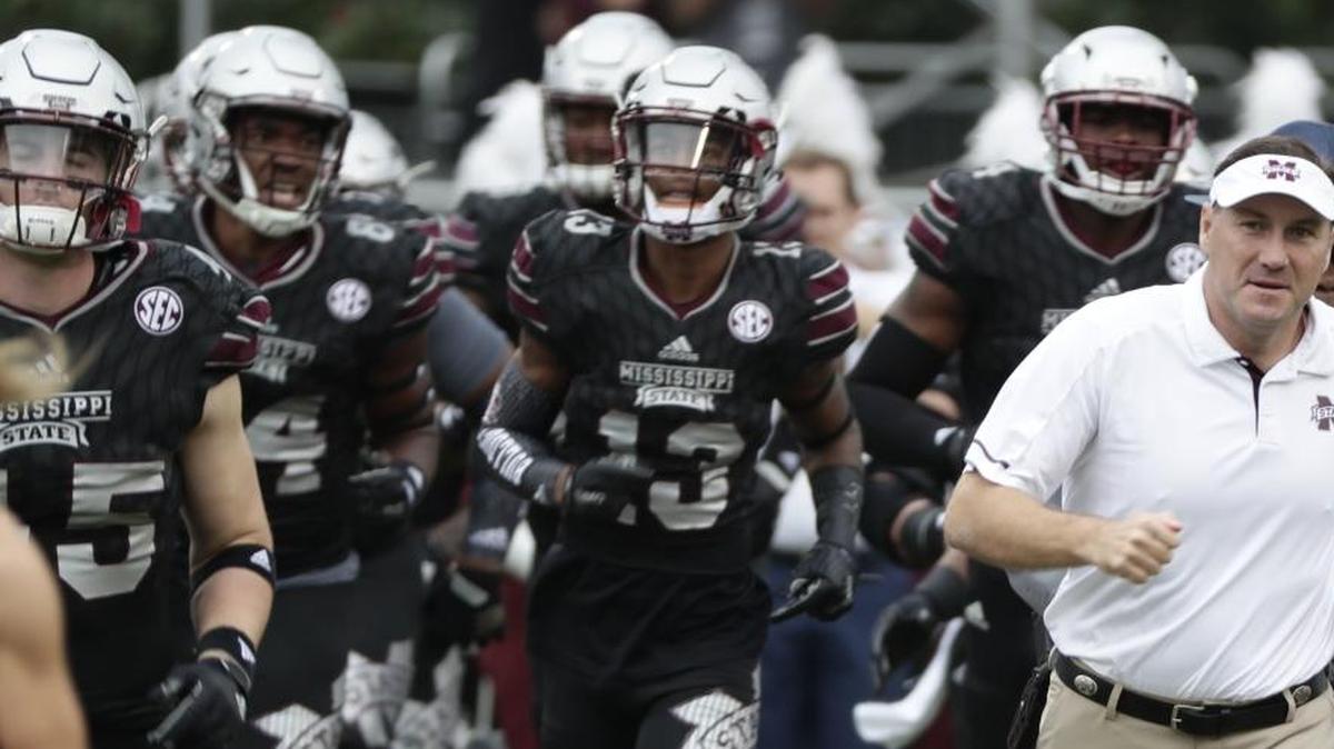 Mississippi State head coach Dan Mullen leads his team onto the field for their NCAA college football game against Massachusetts in Starkville, Saturday, Nov. 4, 2017. No. 21 Mississippi State won 34-23. The Bulldogs host Alabama on Saturday.