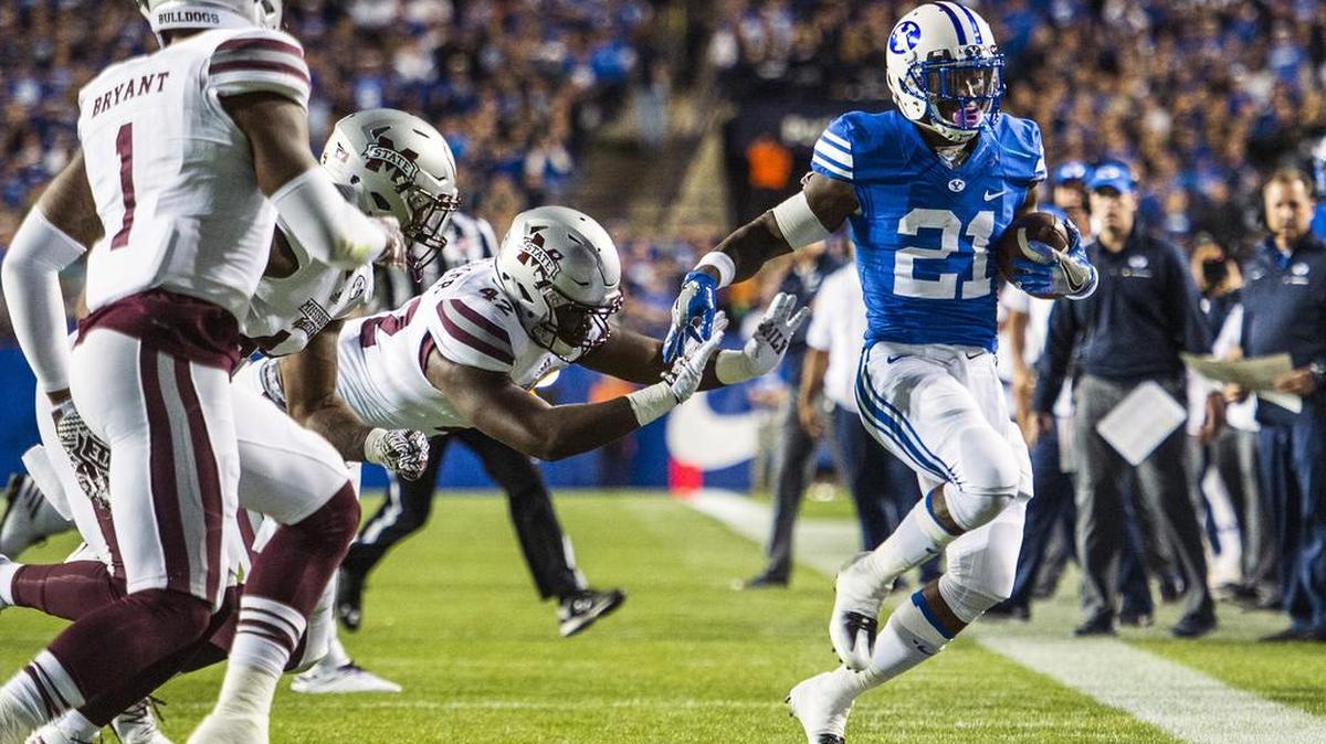 Mississippi State defensive lineman Marquiss Spencer (42) pushes BYU running back Jamaal Williams (21) out of bounds in Provo, Utah, Friday.