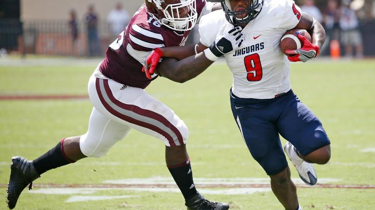 Mississippi State defensive lineman Johnathan Calvin, tries to tackle South Alabama running back Tyreis Thomas (9) . The Jaguars shocked MSU 21-20.