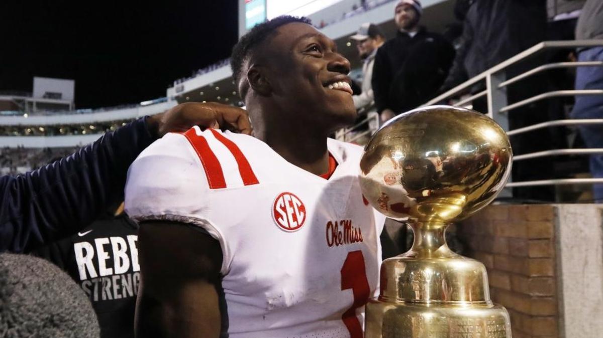 Ole Miss wide receiver A.J. Brown carries the Egg Bowl trophy following the team's 31-28 win over Mississippi State in an NCAA college football game in Starkville, Thursday, Nov. 23, 2017. Brown was awarded the Conerly Trophy on Tuesday night as Mississippi’s top Collegiate player.