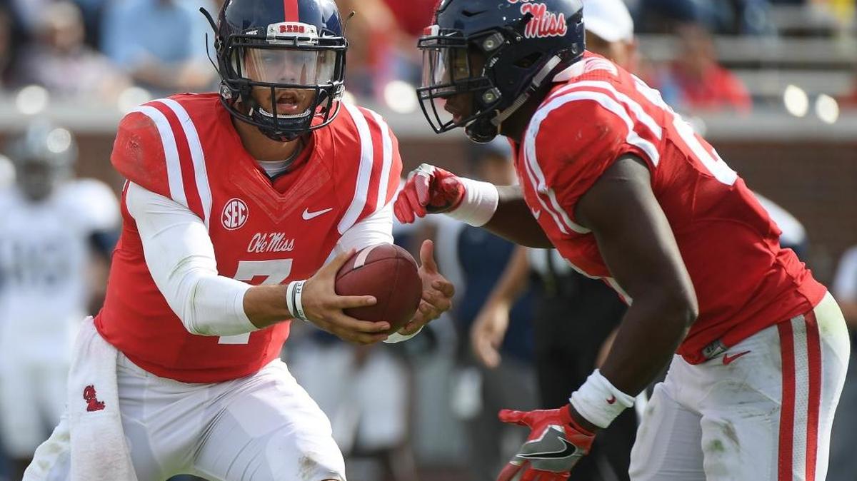 Ole Miss quarterback Jason Pellerin (7) hands the ball off to running back Akeem Judd (21) during the second half against Georgia Southern in Oxford Saturday.