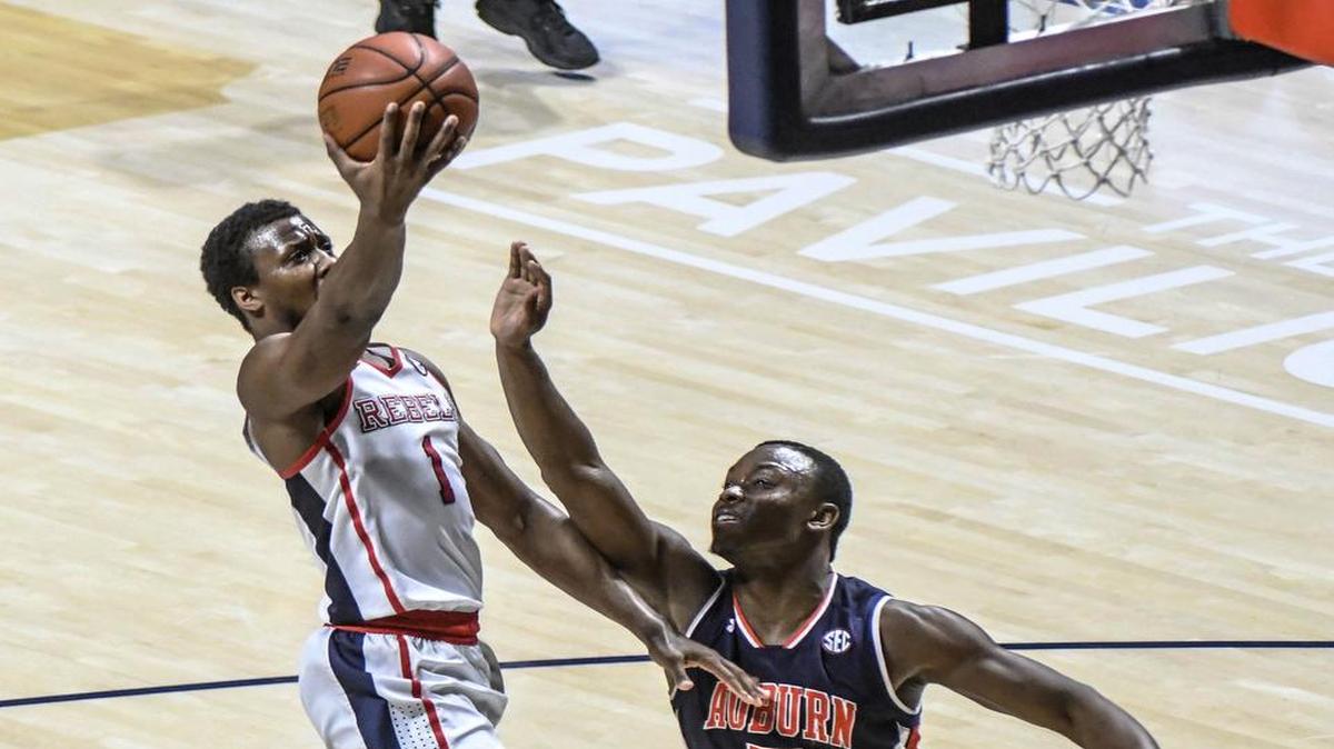 Ole Miss guard Deandre Burnett (1) shoots against Auburn guard Mustapha Heron (5).