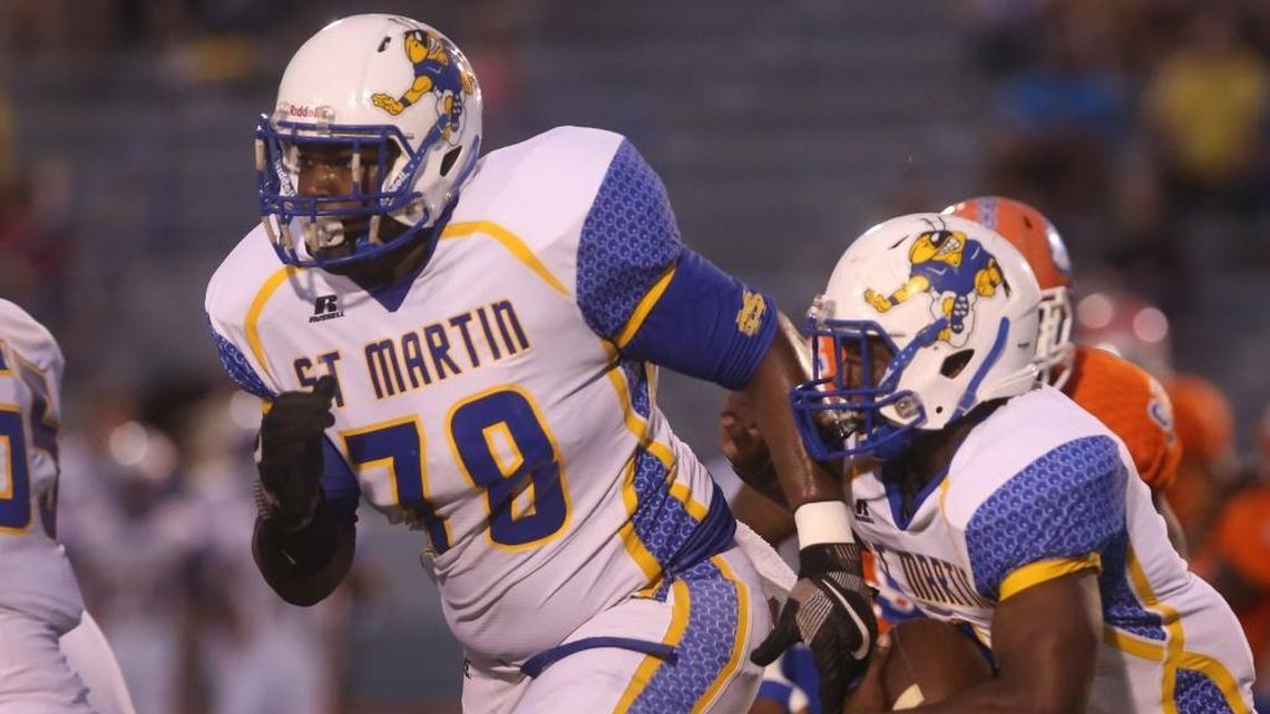 St. Martin’s offensive lineman Brandon Cunningham leads the way for running back Jovann “Ham” McGee on a carry against Gulfport on Sept. 22, 2017, at Milner Stadium in Gulfport.