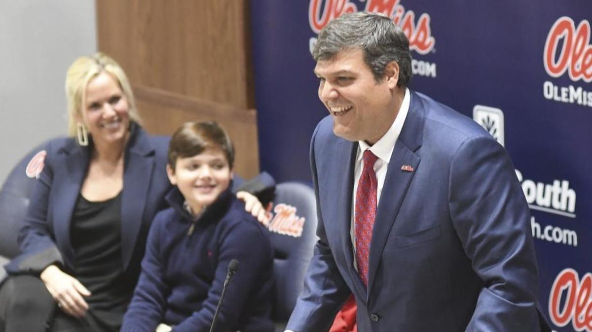 Matt Luke speaks after being introduced as the new Ole Miss football coach on Monday. At left looking on are Luke's wife Ashley and sons Harrison and Cooper, obscured behind his father.