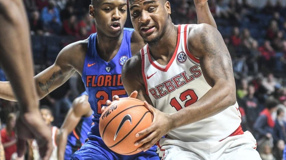 Ole Miss’ Bruce Stevens (12) is defended by Florida's Keith Stone (25).