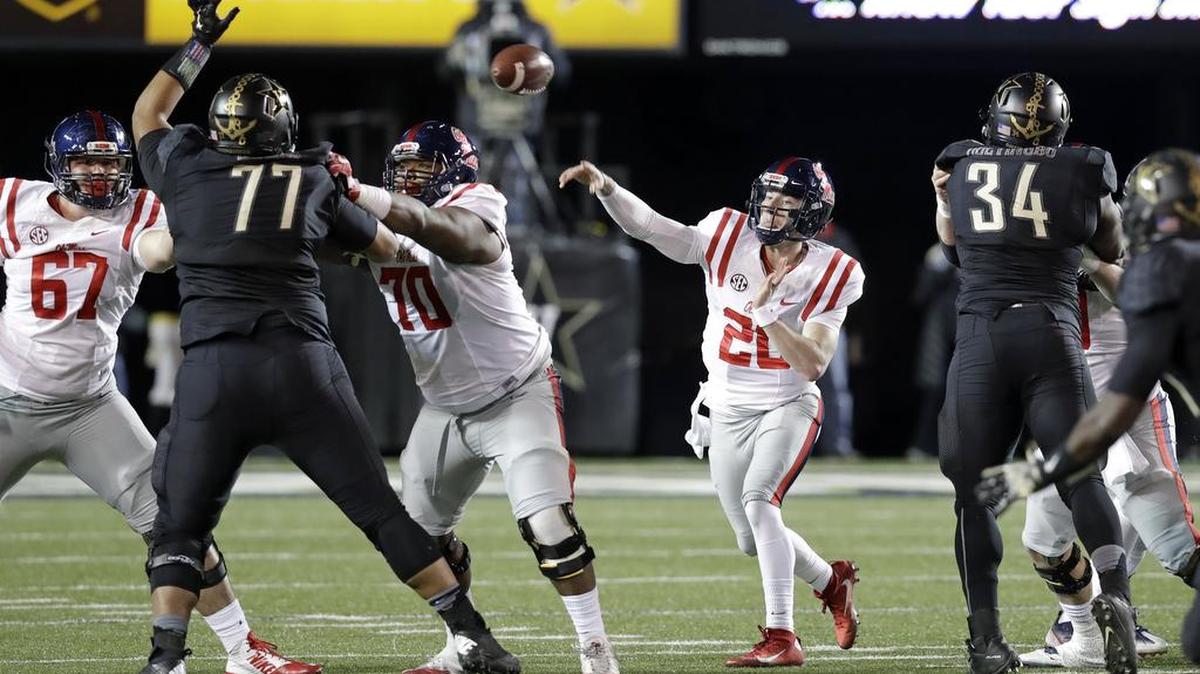 Mississippi quarterback Shea Patterson (20) passes as he is rushed by Vanderbilt defensive tackle Nifae Lealao (77) and defensive end Dare Odeyingbo (34).
