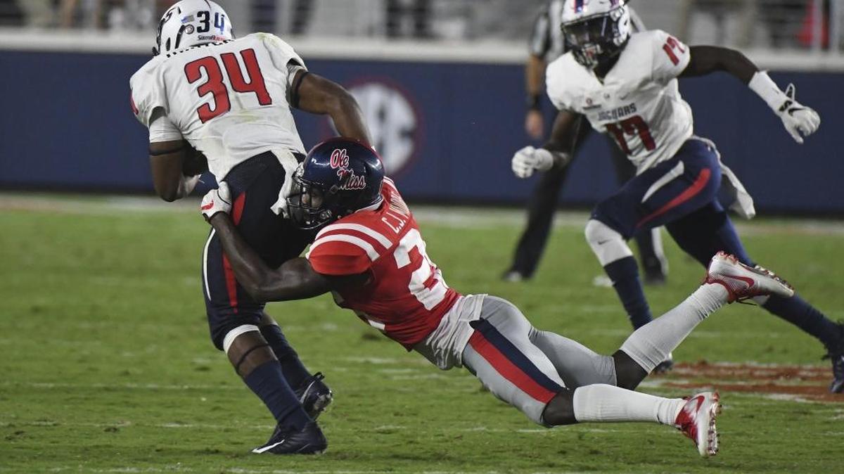 Ole Miss defensive back C.J. Moore (26) tackles South Alabama running back Berron Tyson (34) during the game in Oxford on Saturday.